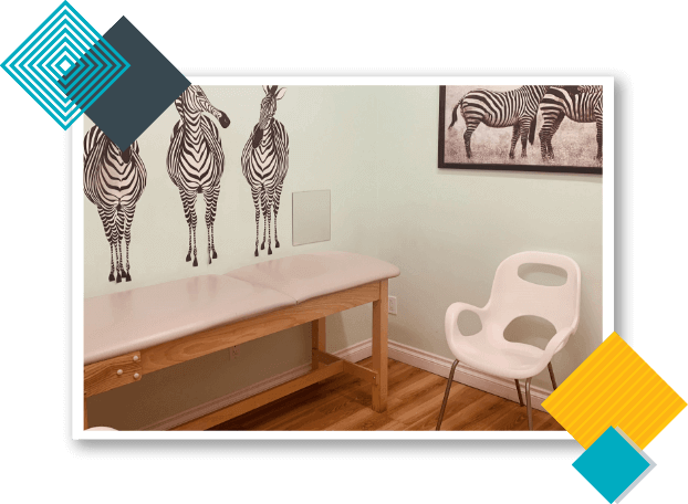 California Kids Pediatrics Clinic Care Unit with zebra painting on the wall, pediatric examination table, and a white chair.