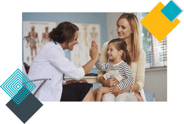 A pediatrician gives a high five to toddler cradled by her mother during her well child visit appointment.